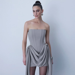 Detail of grey tube dress with structured corset bodice and elegant side draping details