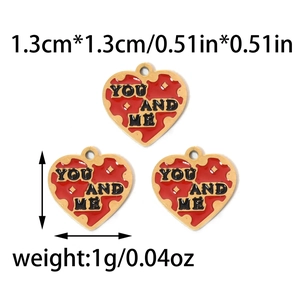 Close-up of red and gold heart pendants engraved with You and Me in 1.3cm size