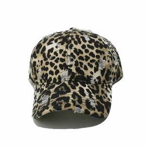 Close-up of distressed leopard print baseball cap with ripped edges and vintage canvas detail