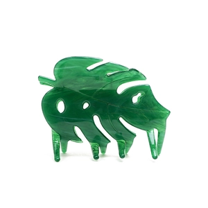 Detailed view of the green acetate monstera leaf hair claw clip with a glossy finish