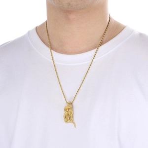 Close-up of 18k gold snake pendant necklace worn by a model in a minimalist style
