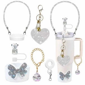 6-piece set of white glitter accessories for tumblers featuring rhinestone charms and straw cap