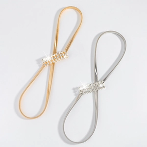 Detailed view of silver and gold elastic spring waist chains with rhinestone buckles