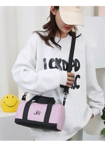 Pink and black nylon crossbody pillow bag with JLP logo and adjustable strap