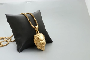 Retro golden lion head pendant necklace with box chain for men and women on black display