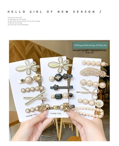 Detailed close-up of 30pcs gold hair clips set with pearls and rhinestones on card