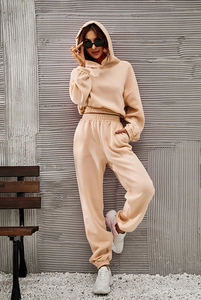 Detail view of beige two-piece loungewear set featuring hoodie and joggers on a model