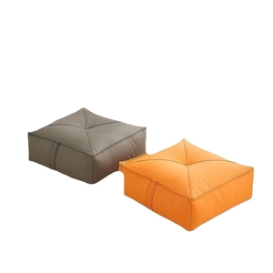 Square faux leather floor cushions in grey and orange with side handles and tufted center
