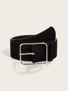 Detail of black suede wide belt with a square silver metal buckle on a white surface