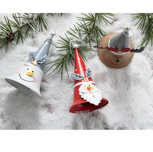 Detail of Christmas metal bells featuring Santa, Snowman and Reindeer on artificial snow