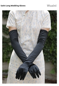 Detail of elegant long black satin gloves paired with a blue lace dress for weddings