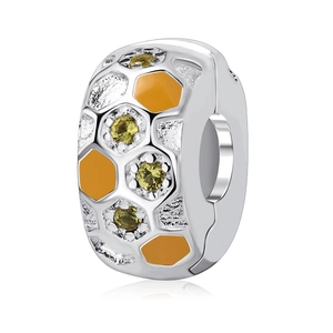 Detailed view of 925 sterling silver honeycomb bead with orange enamel and yellow gems