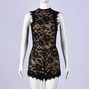 Close-up of intricate black floral lace texture with beige lining on sleeveless romper