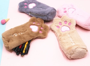 Detailed view of four colorful plush animal paw pencil cases with soft fur and embroidery