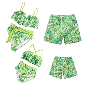 Family matching swimwear set with tropical green leaf print for beach and sun protection