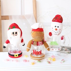 Close-up of three festive Christmas candy jars with Santa, Snowman and Gingerbread man