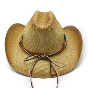 Detail of hand-woven western straw cowboy hat featuring turquoise beads and leather cord decoration