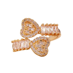 Macro shot of gold heart ring featuring baguette-cut crystals and pavé-set accents