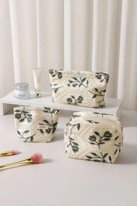 Three-piece beige cotton linen toiletry bags set with elegant floral embroidery patterns