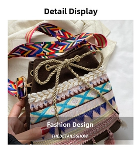 Close-up of bohemian bucket bag with colorful geometric embroidery and pink tassels