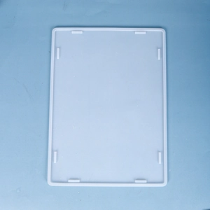 Top view of translucent white silicone storage box mold with positioning lugs on blue background