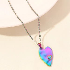Detailed close-up of an iridescent rainbow heart pendant on a fine stainless steel chain
