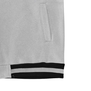 Detail of the gray cotton jacket showing the striped ribbed hem and side pocket texture