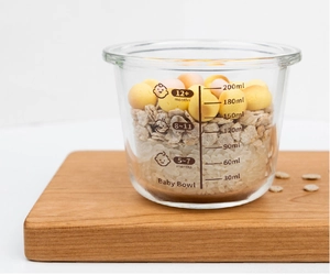Macro shot of 200ml glass baby food container with clear scale marks and age indicators