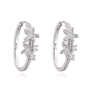 Silver starfish hoop earrings with sparkling zircon stones on a white background