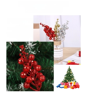 Macro detail of glittered Christmas berry stems in red, gold and silver for holiday DIY