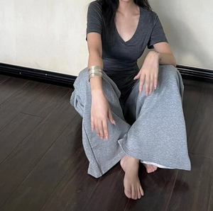 Detail of grey V-neck short sleeve T-shirt paired with matching casual wide-leg sweatpants