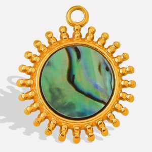 Macro shot of 304 stainless steel gold sun pendant with abalone shell inlay details