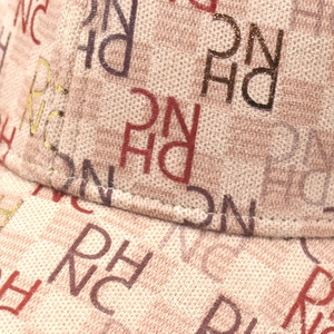 Macro shot of high-density fabric with vintage RHNC letter print on baseball cap