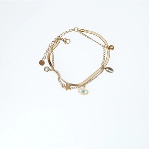 Gold-plated layered Evil Eye bracelet featuring star, shell, and crystal charms