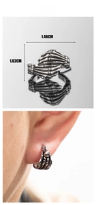 Detail view of gothic skeleton hand earrings with dimensions and ear-on model shot