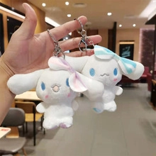 Detail of plush astronaut bunny keychains with pink and blue bows and metal clips