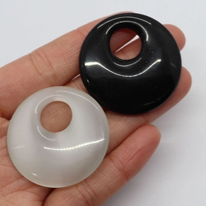 Polished 40mm round natural stone cat eye pendants in black and translucent white colors