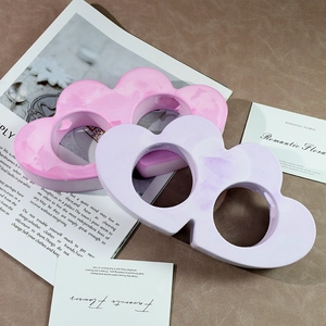 Detailed view of cloud-shaped vases in pink and purple with marble texture