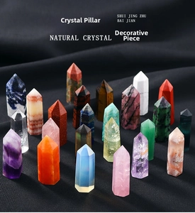 Variety of polished natural crystal hexagonal pillars on dark textured fabric