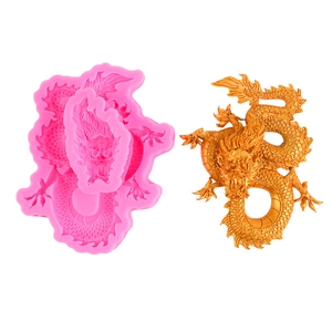 Pink silicone dragon mold and gold finished 3D dragon figure on white background