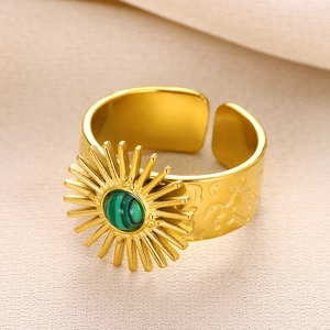 Macro view of gold vintage sunburst ring with green malachite stone inlay details