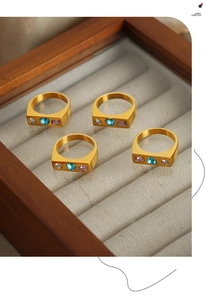 Macro shot of 18K gold plated heart zircon rings in a premium gray velvet jewelry box