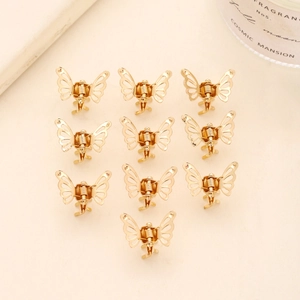 Detailed set of 10 golden metal butterfly hair clips in a neat flat lay arrangement