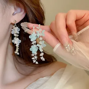 Long floral tassel earrings with green and white crystals on elegant gold alloy base
