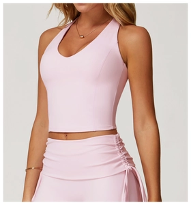 Detailed close-up of light pink sports vest featuring a deep V-neck and slim fit tailoring