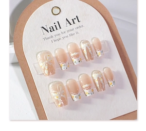 Macro detail of 3D bowknot press-on nails with cat-eye glitter and floral nail art