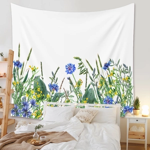 Detail of bohemian tapestry with blue cornflowers and yellow wildflowers in bedroom