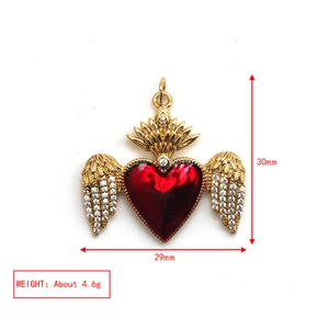 Detail of red heart wing pendant with dimensions 30mm x 29mm and weight 4.6g