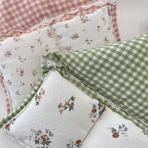 Detail of macaron plaid storage bags with delicate white lace trim and floral patterns