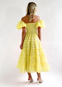 Detailed back view of yellow plaid off-shoulder midi dress with elastic smocked bodice